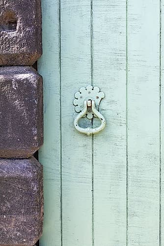 Masham, Ripon, North Yorkshire, England. Handle on an old green wooden door. European Print